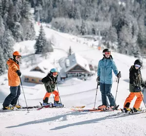 Familie bei der Pratz-Bäume-Abfahrt mit Blick zur UAlm und zur Mittelstation